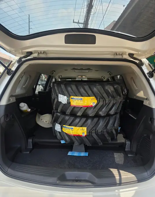 Tractor tires loaded in the back of an SUV