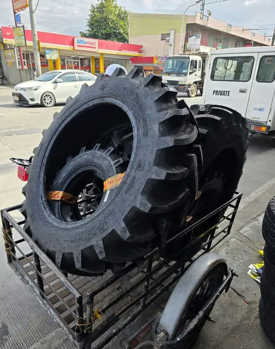Tractor tires tied down on a trailer